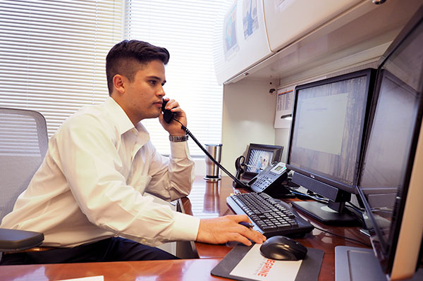 man professional guy businessman on phone looking at computer monitor 1031 royalty exchanges peregrine dallas texas